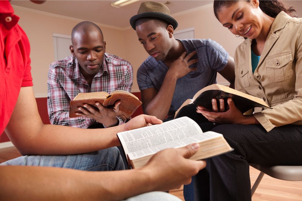 A small group of people reading and discussing the Bible together